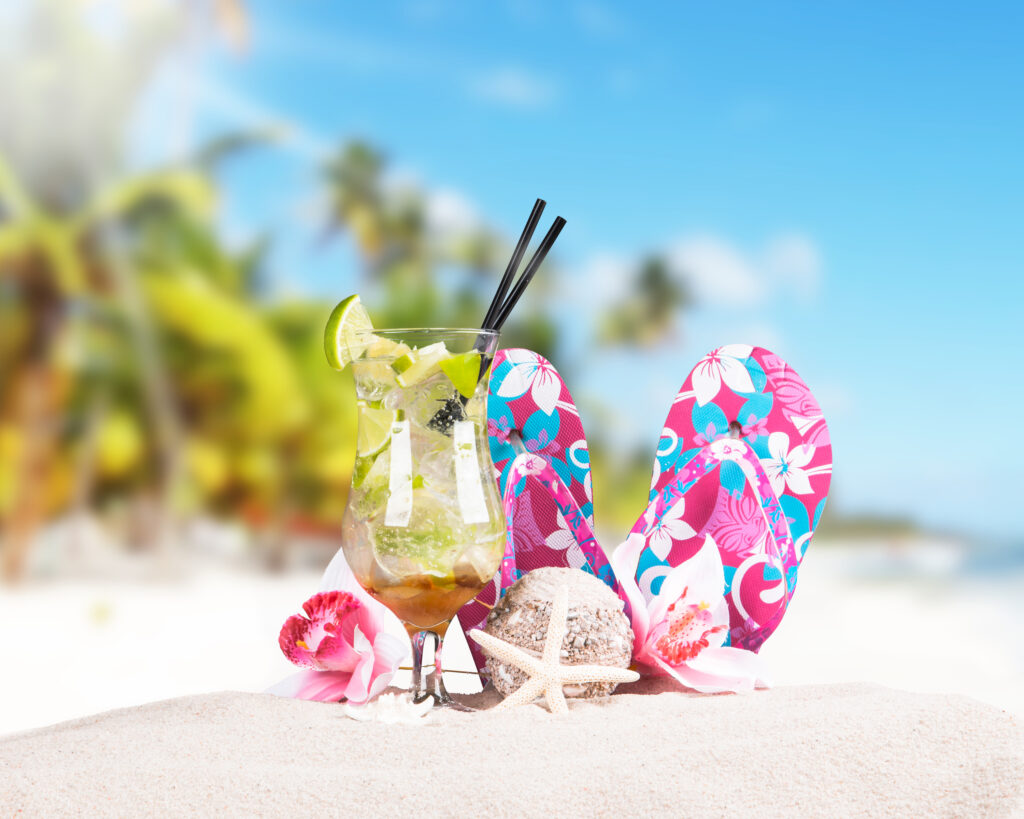 Mojito drink and summer accessories with tropical beach background