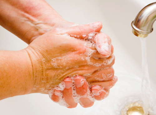 Washing hands under running water.