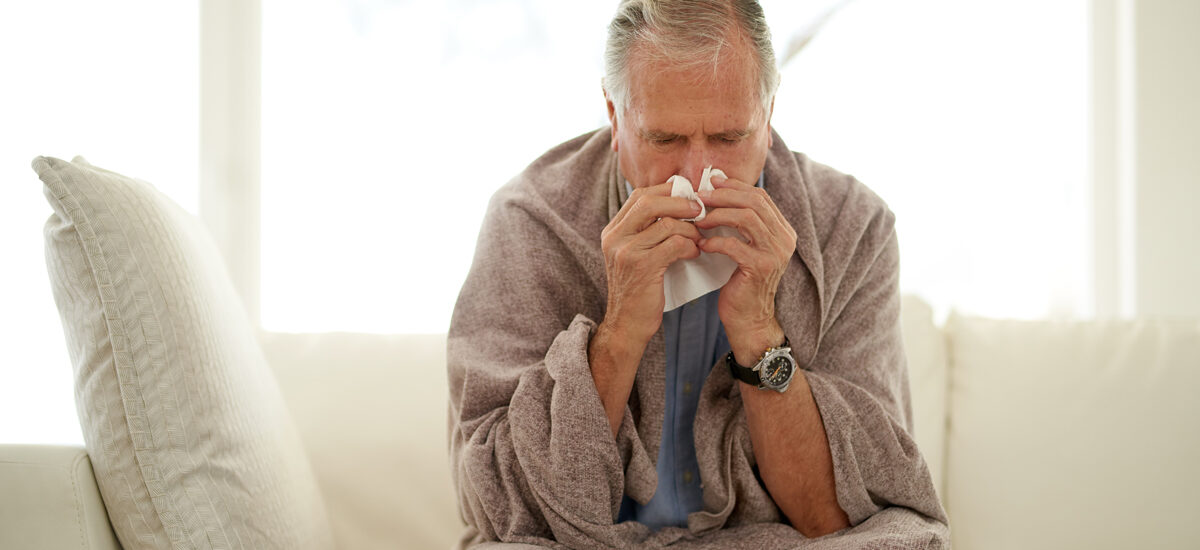Senior male sick at home with the flu